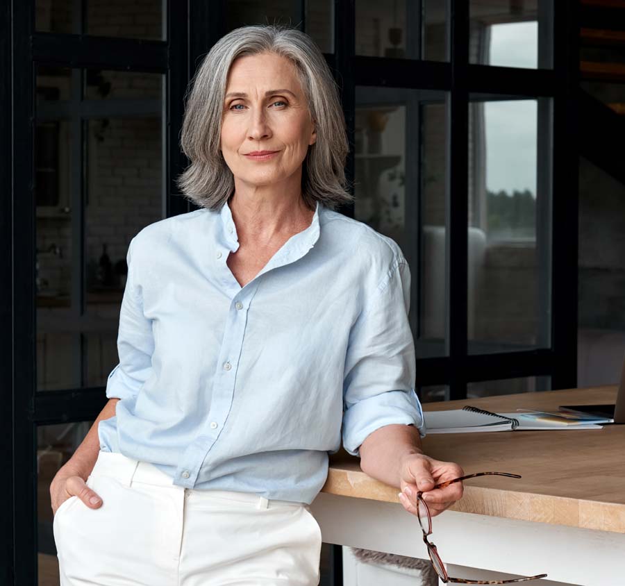 Older woman leaning on table