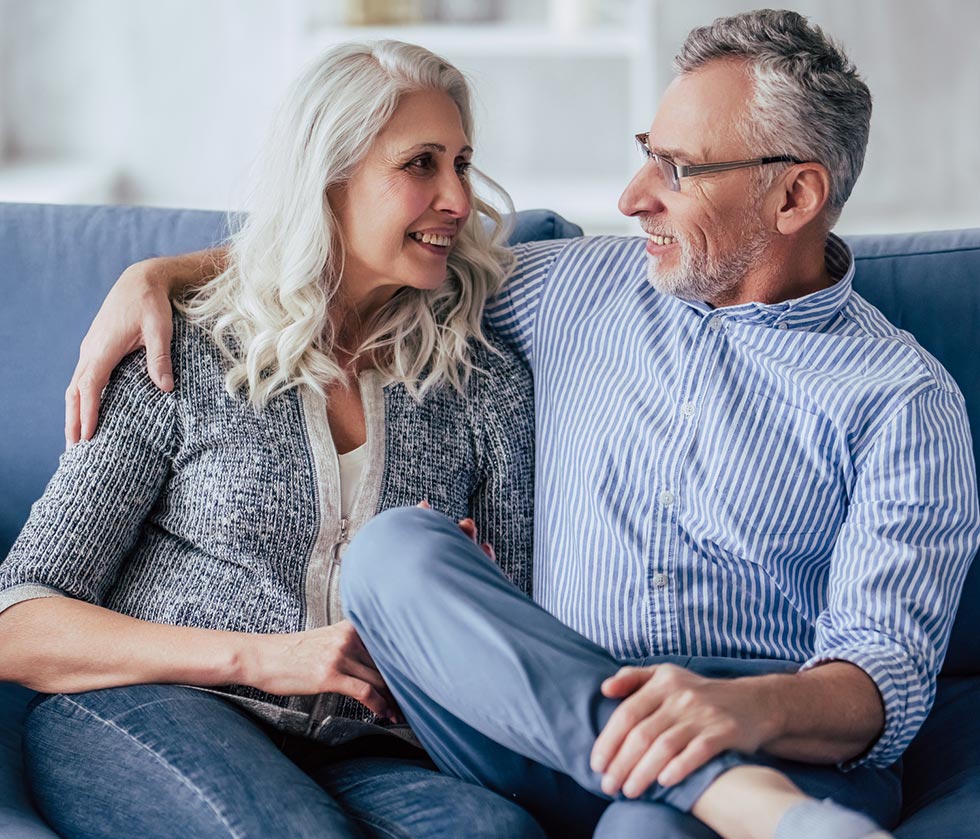 Older couple looking at each other smiling.